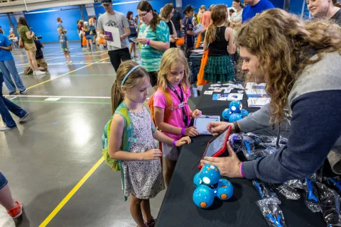 Kids work on a hands-on science demonstration at Neutrino Day