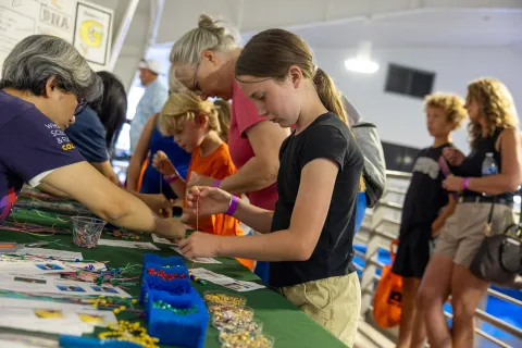 A child works on a hands-on science demonstration at Neutrino Day