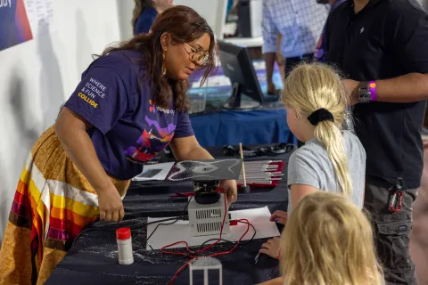 Kids work on a hands-on science demonstration at Neutrino Day