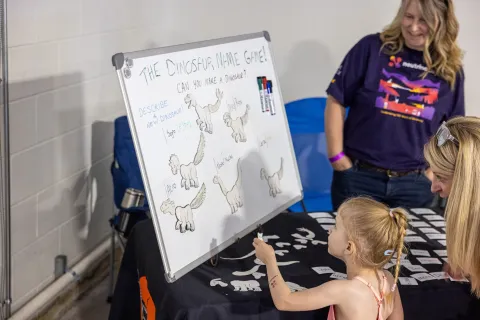 Kids work on a hands-on science demonstration at Neutrino Day