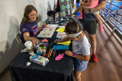 Kids work on a hands-on science demonstration at Neutrino Day