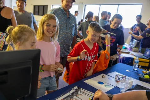 Kids work on a hands-on science demonstration at Neutrino Day