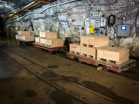 Rail cars loaded with heavy wooden crates in a drift