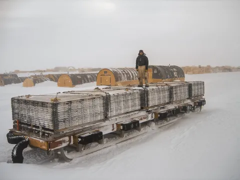 Susan Thompson stands atop a delivery platform in Antarctica