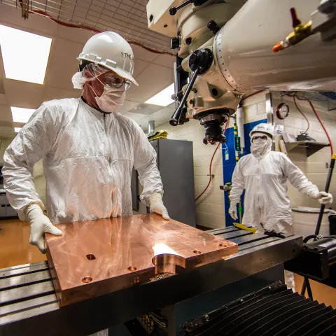 Working in a cleanroom nearly a mile underground, Randy Hughes (foreground) is the primary on-site machinist for the font style=