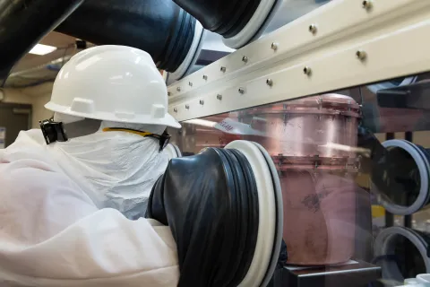 Germanium is a semiconductor like silicon but must operate at approximately minus 200 degrees Celsius. Using a nitrogen-gas-filled glove box to keep components clean, Matthew Green of North Carolina State University and ORNL places detector assemblies in 