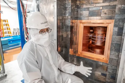 Vincente Guiseppe, co-spokesperson of the Majorana Collaboration and a research staff member at ORNL, in front of the Majorana Demonstrator shield on the 4850 Level of SURF. Photo by Nick Hubbard 