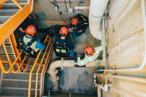 ert members assess the training mannequin at the base of a stairwell