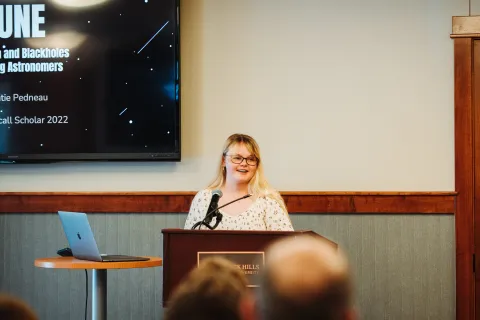 Katie Pedeau presents about the DUNE experiment during the Davis-Bahcall Scholars Program's final presentations. 
