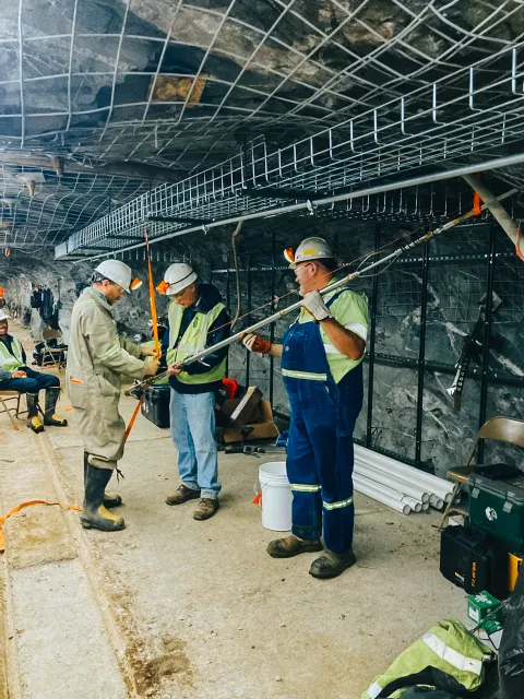 three researchers preform wireline logs 