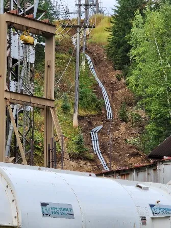 Overhead electrical wires on the left side of the image were replaced with an underground duct bank on the right side of the image