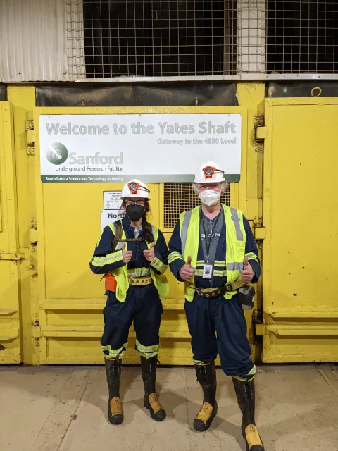 Two researchers stand in front of the Yates Station