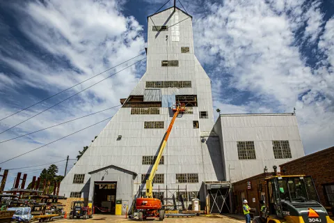 Crews replace paneling on the shell of the Ross Headframe.
