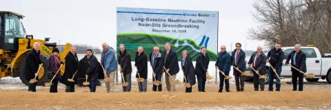 16 people break ground with shovels