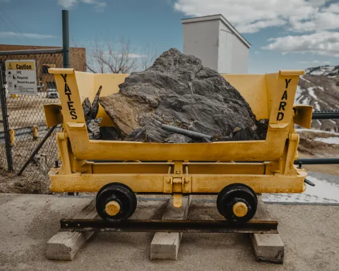 A railcar filled with rock sits outside the E&O Building at Sanford Lab