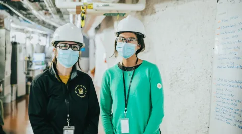 Gina Gibson (left), SURF AiR program coordinator, and Leekyung Kang (left), 2021 SURF AiR, during a tour of the 4850 Level. 