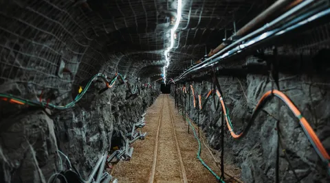 an underground drift at SURF is lit by a single string of lights on the back of the drift