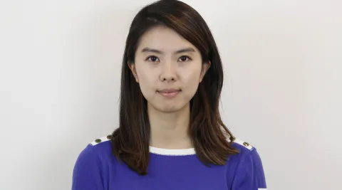 headshot of a person standing against a blank wall