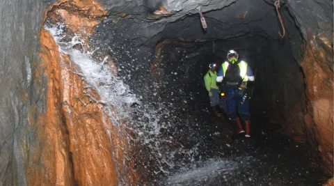 Excess water spills out of borehole in underground drift