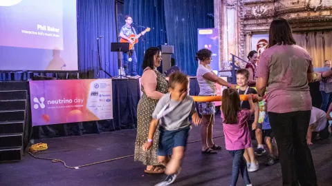 Children dance during a Neutrino Day performance 