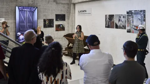 Gina Gibson speaks to a crowd gathered for the opening of the exhibit.