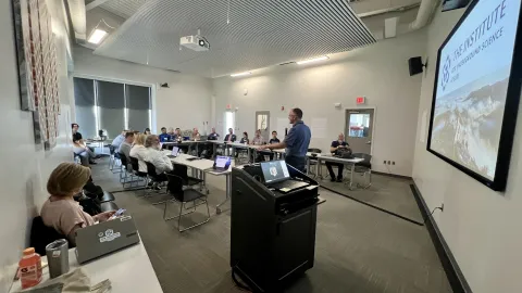 Mike Headley speaking to a group of peopple gathered at the Sanford Lab Homestake Visitor Center classroom for the GPN Quantum Research Collaboration Workshop in July of 2024