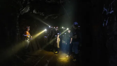 Students learn underground in the darkness with headlamps during the 2024 Mine Rescue Competition 