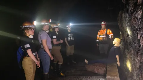Students learn underground in the darkness with headlamps during the 2024 Mine Rescue Competition 