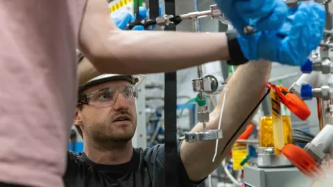 Scientists working on LZ complete hands-on tasks needed to make the experiment run, they are weating rubber gloves and PPE.  