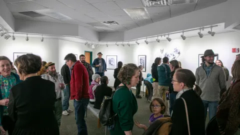 People view art at the artist reception in the Ruddell Gallery