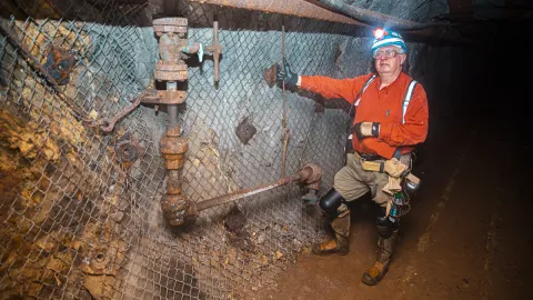 Tom ReganpPoses underground in PPE