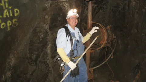 Tom Regan poses underground in PPE