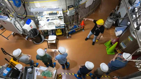 a shot from above showing individuals in hard hats and PPE viewing the LZ experiment 