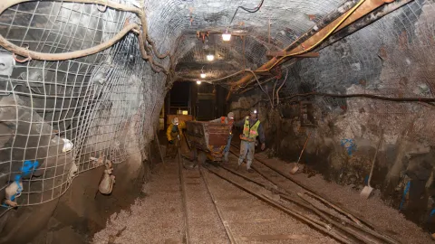 Kip Johnson pulls an rail rock cart underground 