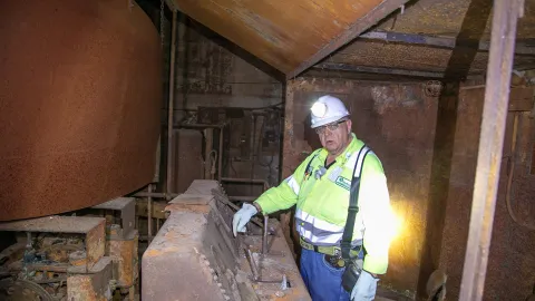 Dan Regan explaining the levers at a historic 4 Winze Hoist operator station 