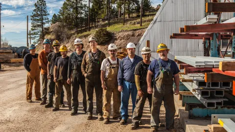 A crew of underground workers pose in the Ross Yard in 2013.