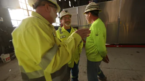 Dan James with SURF engineers inside a head frame at the facility