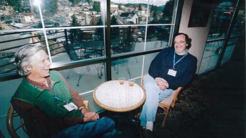 Kevin Lesko and Jon Kotcher in Lead at a conference on underground physics laughs with a fellow scientist