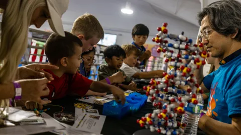 Children engaged in hands-on science learning at Neutrino Day 2025