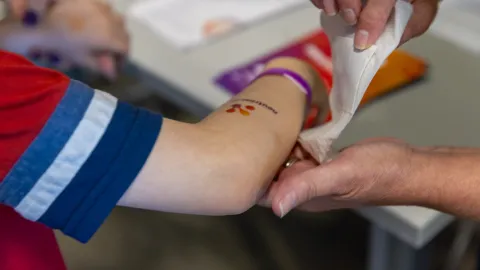 Applying a Neutrino Day Tattoo