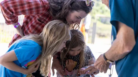 Children and an adults engage in hands-on STEM learning and fun during Neutrino Day 2025 in Lead. 