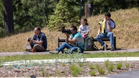 Photographers sitting on the ground shooting