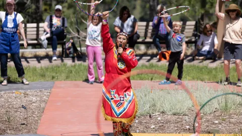 Starr Chief Eagle performs a Lakota hoop dance at Čhaŋgléška Wakȟáŋ  during Neutrino Day 2025 in Lead, SD.