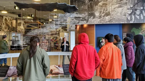 A group of students learning about a 3D model illustrating the underground at SURF.