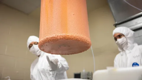 Researchers examine the copper deposited on a mandrel inside the cleanroom at SURF.