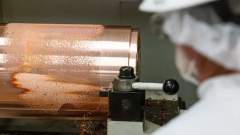 A technician machines copper at SURF.  