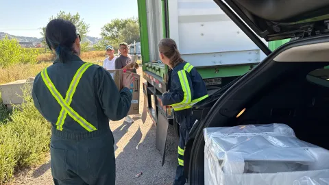 The crew works to load boxes of ultrapure copper into a shipping container with a thick steel box for shielding.