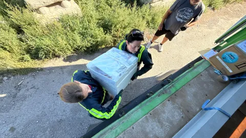The crew works to load boxes of ultrapure copper into a shipping container with a thick steel box for shielding.