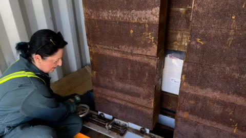 The crew works to load boxes of ultrapure copper into a shipping container with a thick steel box for shielding.