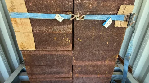 The crew works to load boxes of ultrapure copper into a shipping container with a thick steel box for shielding.